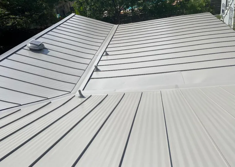 Solar attic fan installed on a metal roof for Roof Ventilation in Defiance